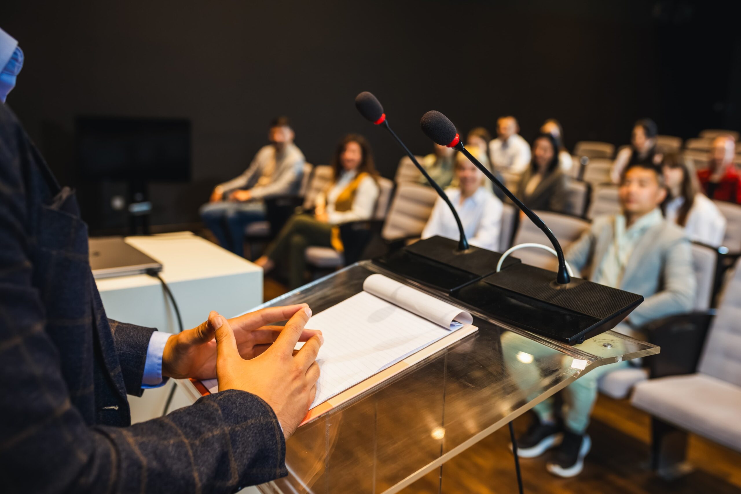Person speaking in front of a crowd